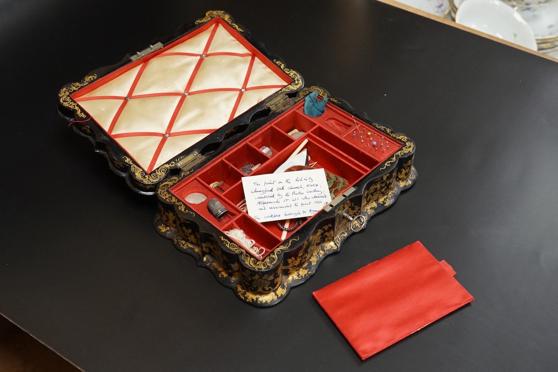 A Victorian Papier mache japanned sewing box, stamped ‘Lane, Birmingham’, the cover with a view of Chingford old church Essex, a boxed Victorian French translation game, by E C Spurin and a papier mache panel (3)